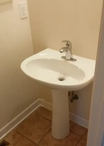 a kitchen with a sink and a stove top oven
