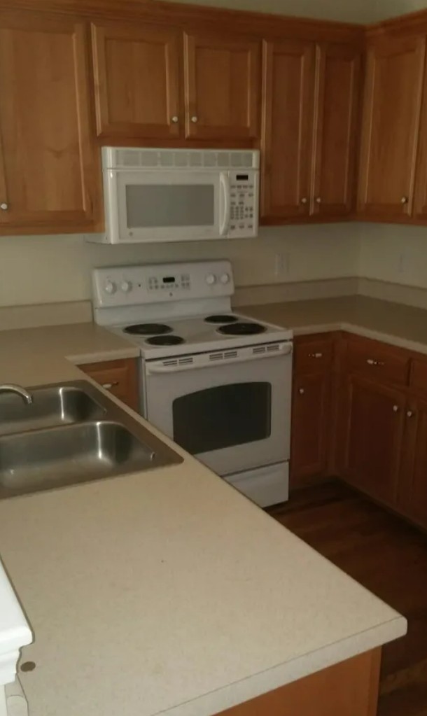 207 Dakota Drive Spring Hill, TN 37174 - Photo 6 of 10 a kitchen with a sink and a stove top oven