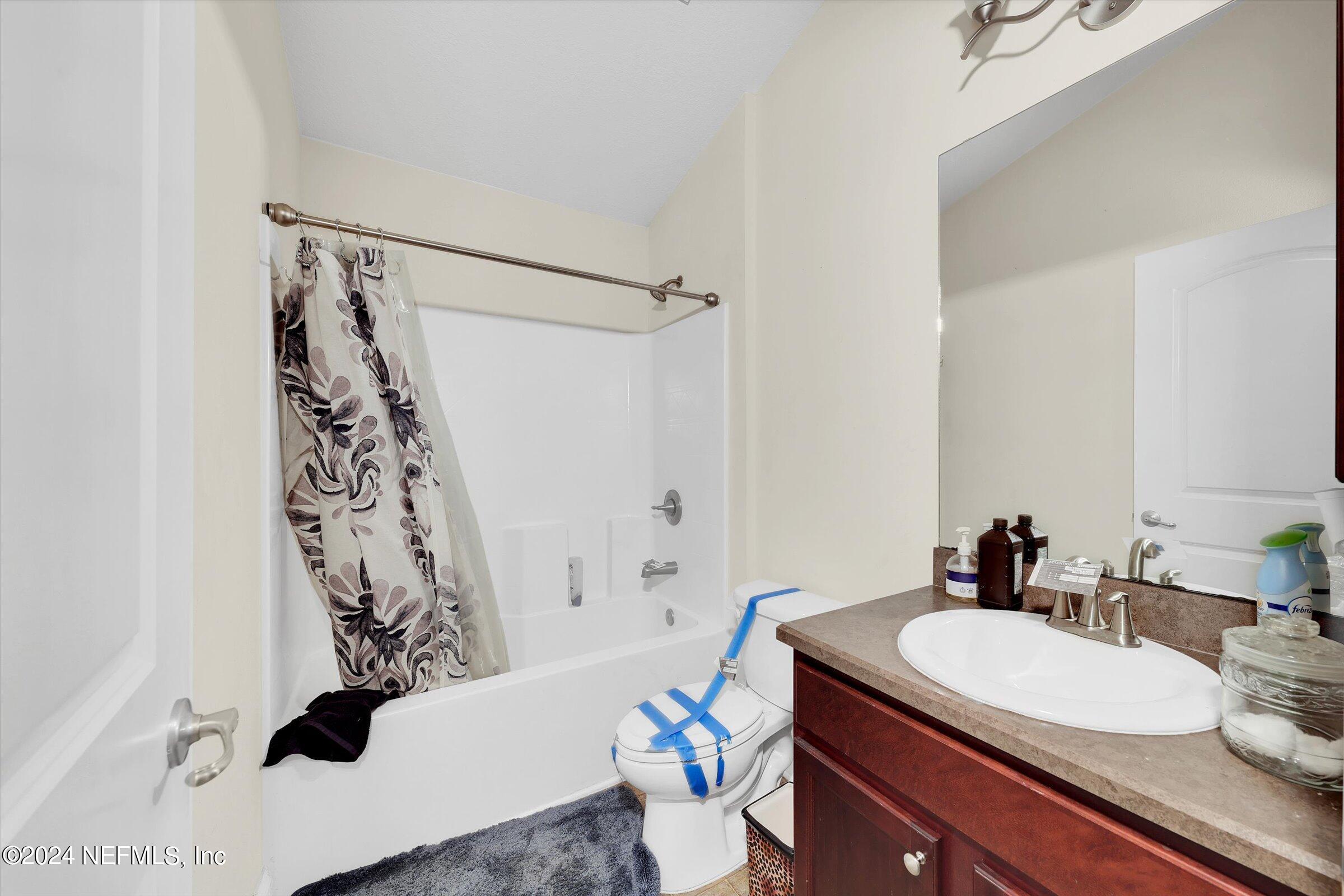 2109 Cherokee Cove Trail Jacksonville, FL 32221 - Photo 17 of 29 a bathroom with a sink a toilet and shower