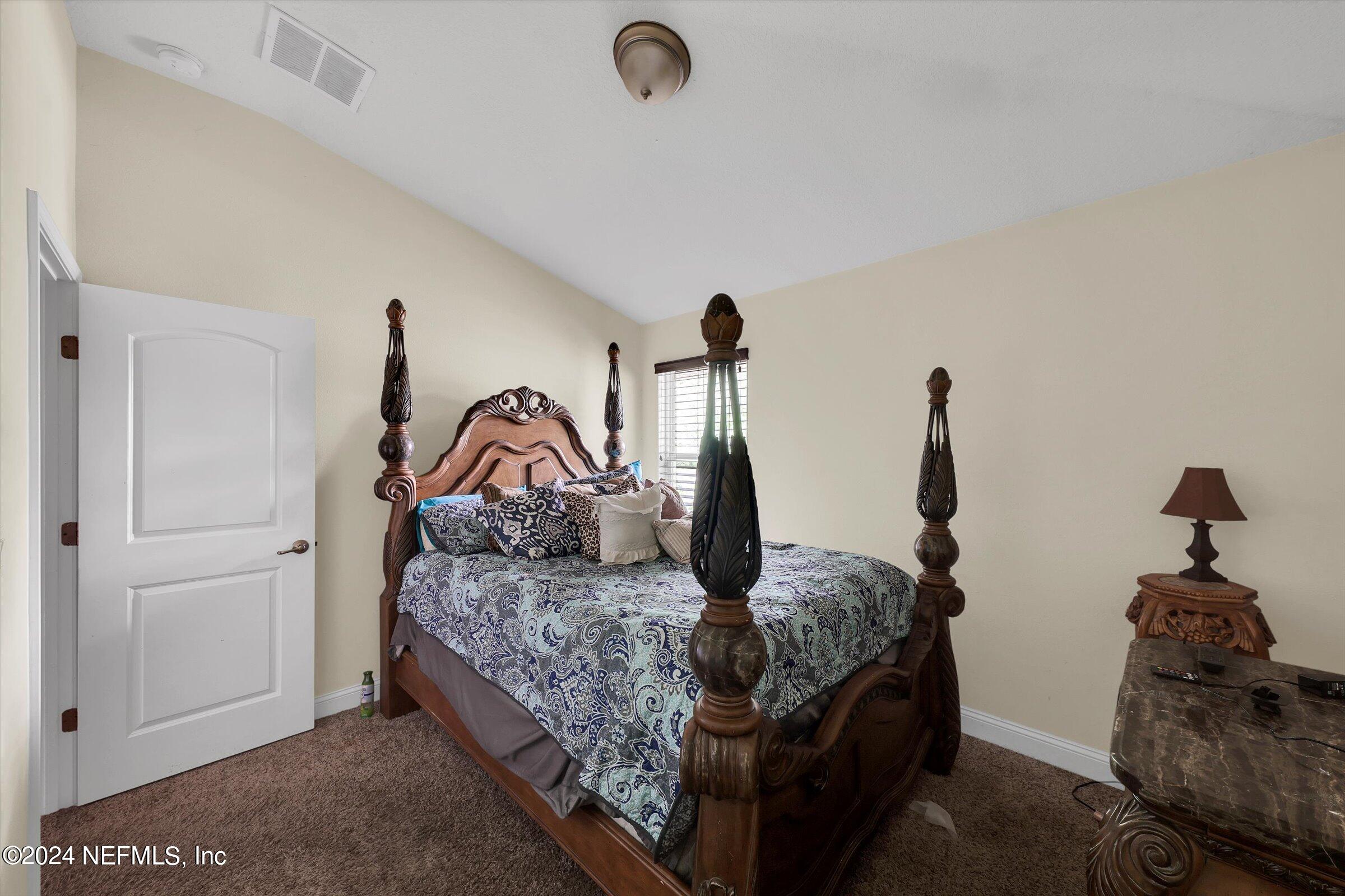 2109 Cherokee Cove Trail Jacksonville, FL 32221 - Photo 18 of 29 a bedroom with bed and a window
