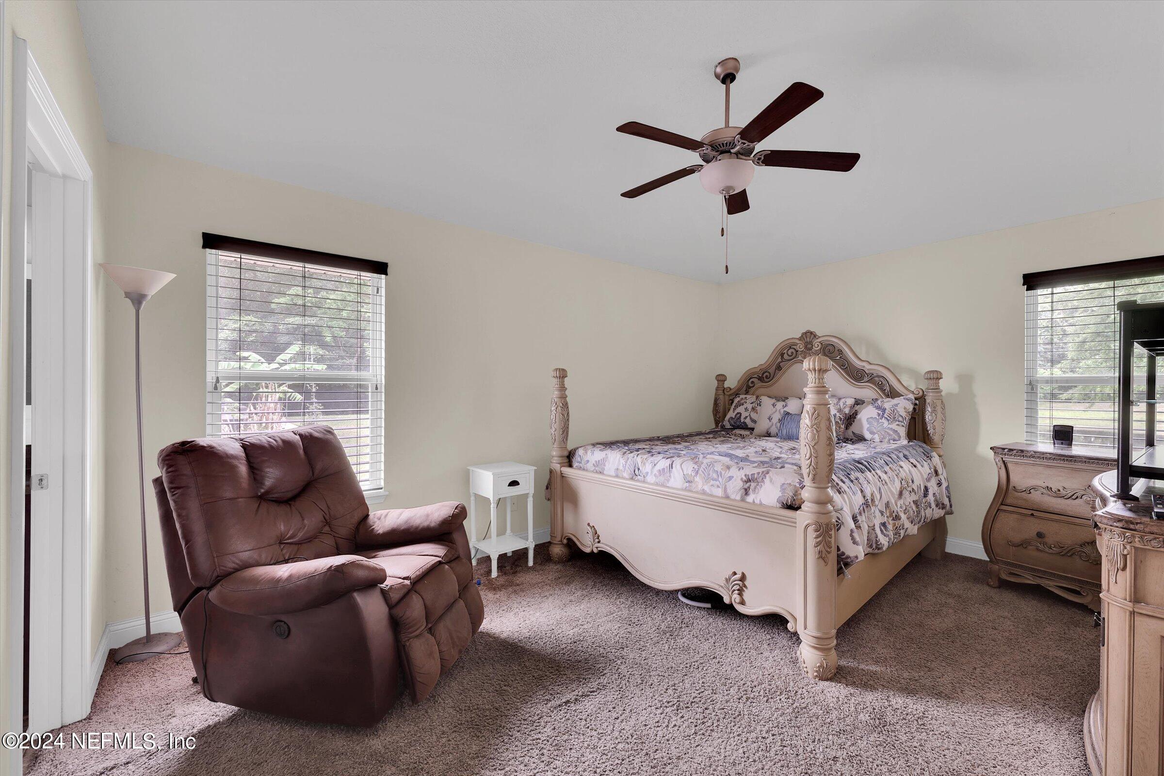 2109 Cherokee Cove Trail Jacksonville, FL 32221 - Photo 21 of 29 a bedroom with a bed and window