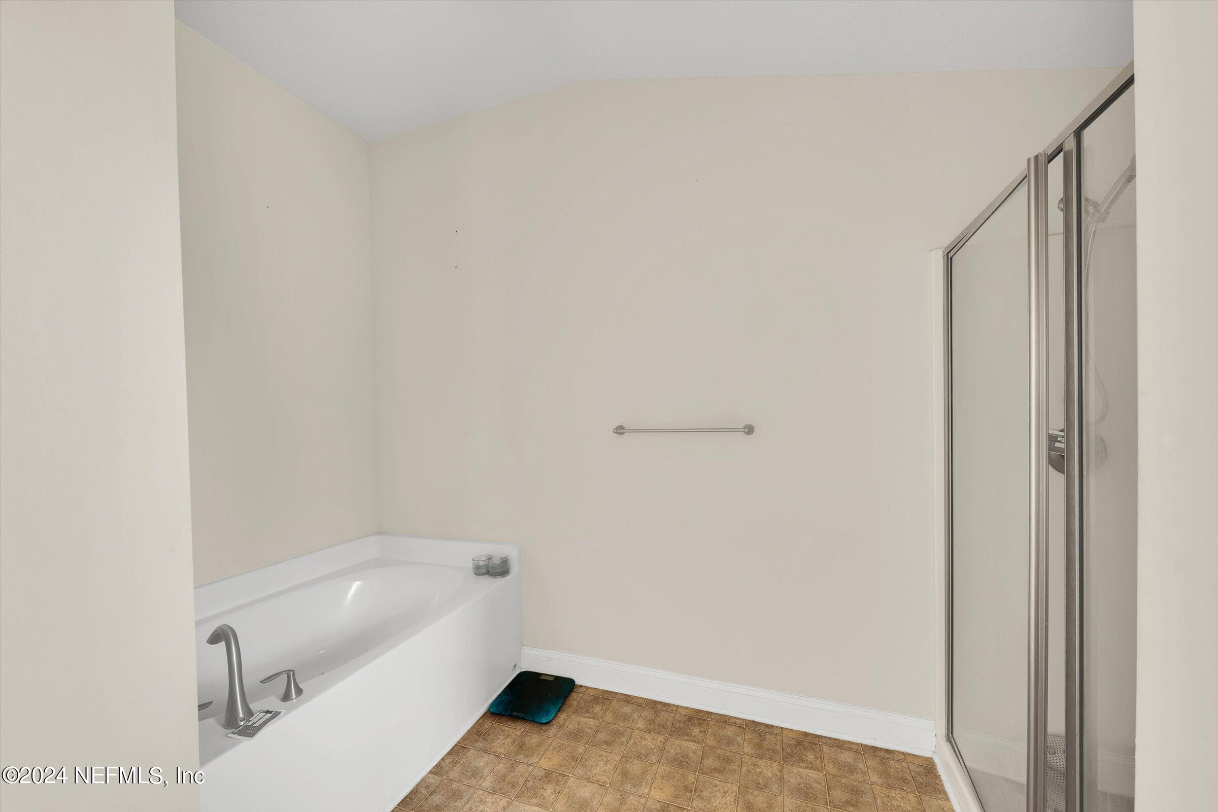 2109 Cherokee Cove Trail Jacksonville, FL 32221 - Photo 24 of 29 a bathroom with a bathtub and a shower