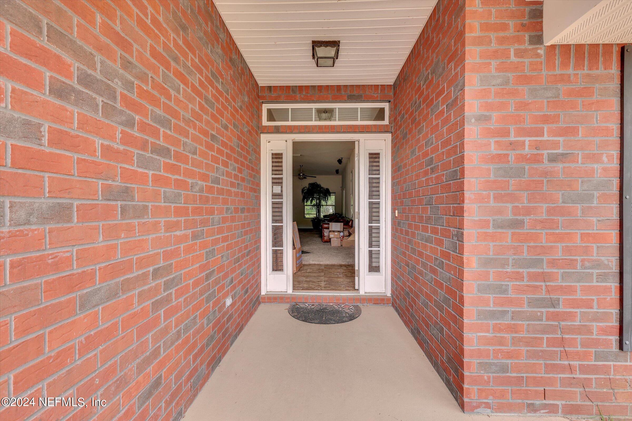 2109 Cherokee Cove Trail Jacksonville, FL 32221 - Photo 3 of 29 a view of a brick house with a large window