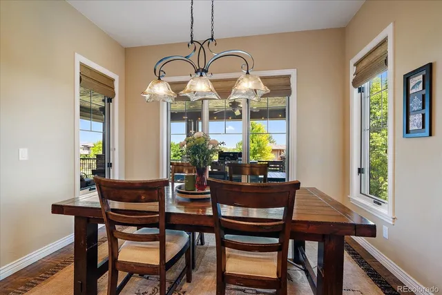 a view of a dining room with furniture and chandelier