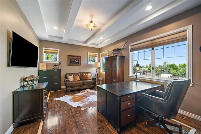 a living room with granite countertop furniture a dining table and a flat screen tv