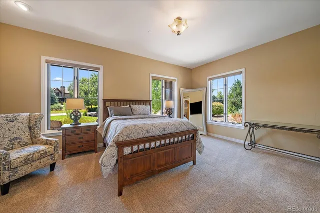 a spacious bedroom with a bed and a couch