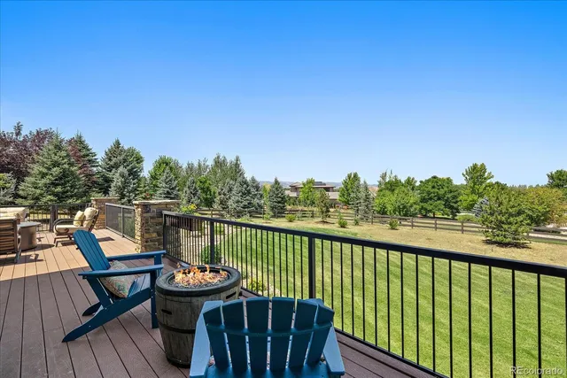a view of a balcony with wooden floor and outdoor seating