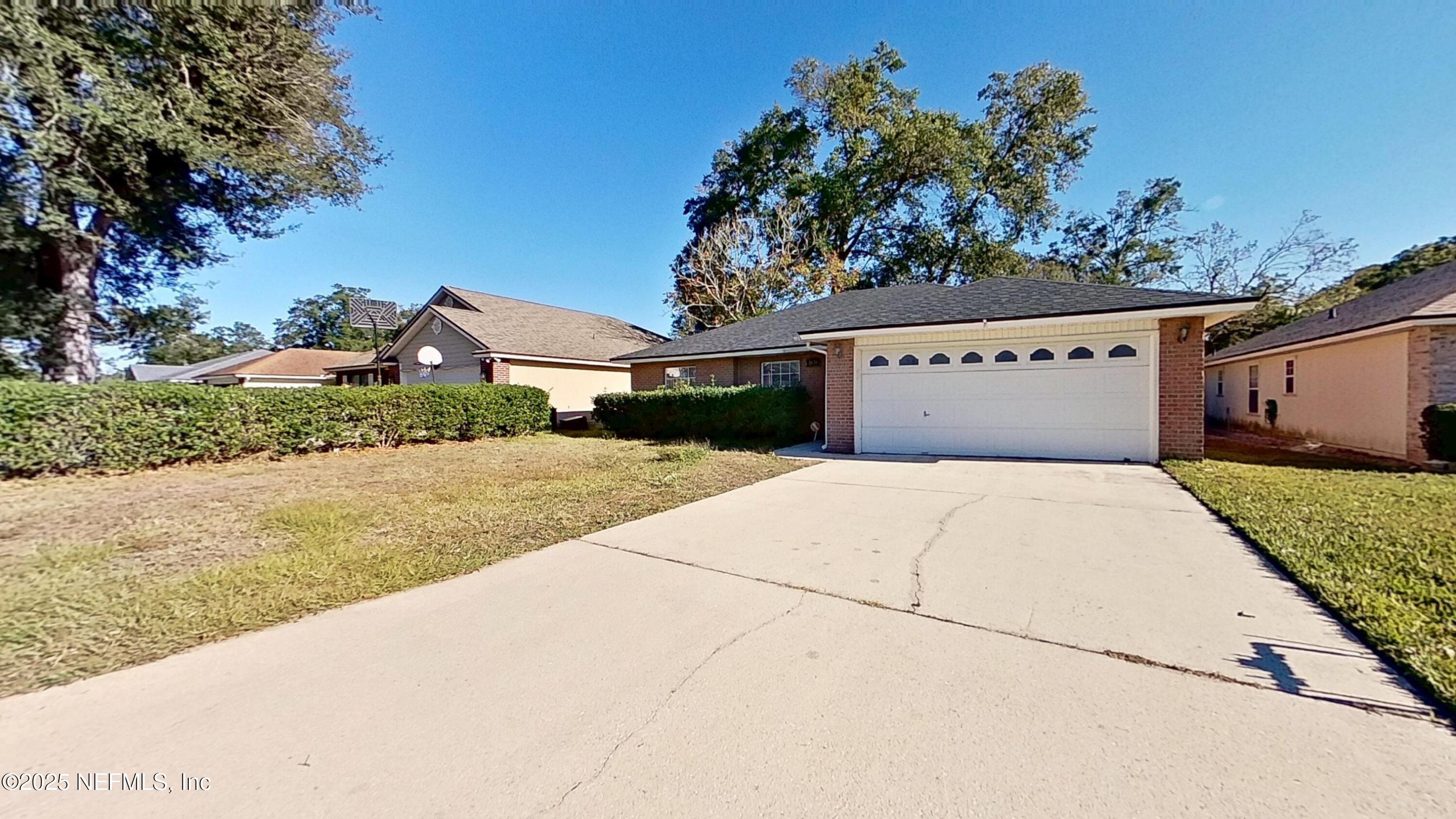 1639 Spring Branch Drive West Jacksonville, FL 32221 - Photo 20 of 25 a front view of a house with a yard and garage