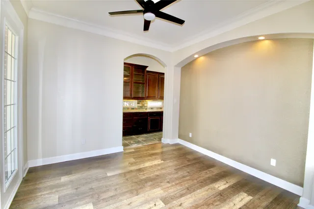 a view of a kitchen with a sink and a ceiling fan