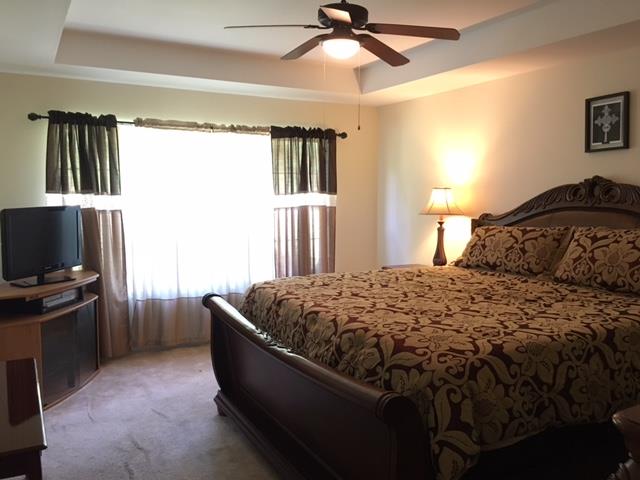 2881 Evergreen Ridge Point Nashville, TN 37217 - Photo 15 of 18 a bedroom with a bed and a flat screen tv