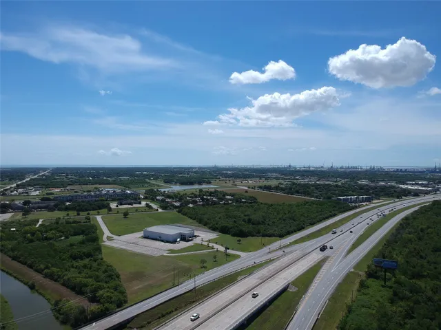 an aerial view of residential houses with outdoor space and river