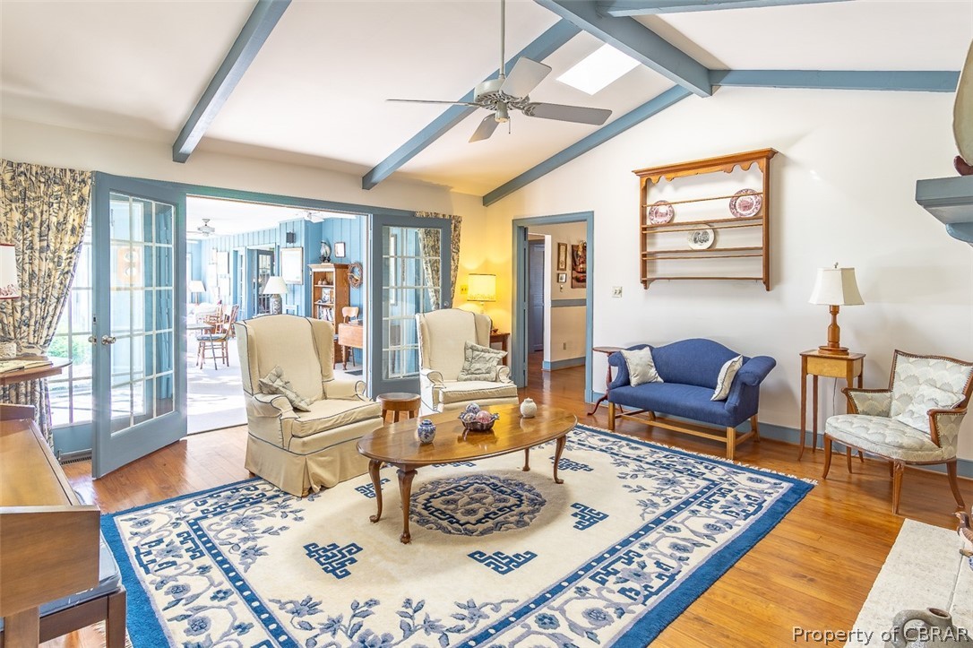 437 Taskmaker Lane Reedville, VA 22539 - Photo 10 of 38 Living room with vaulted ceiling, fireplace and entrance to sunroom