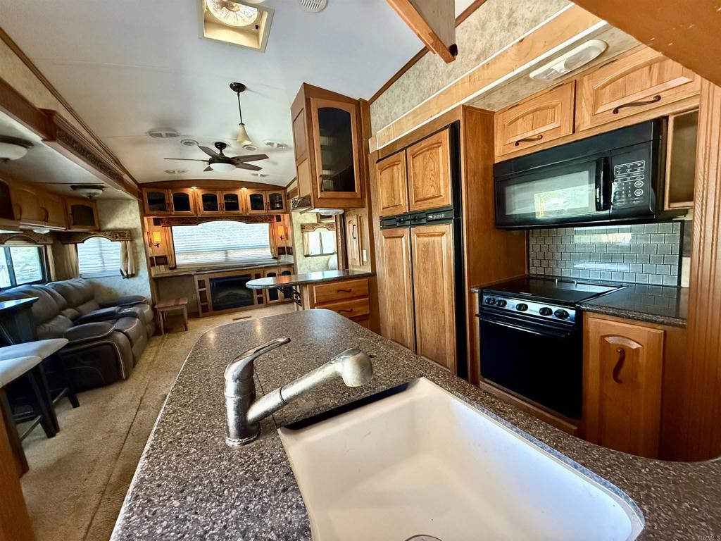 0 Olive Hill Road Fallbrook, CA 92028 - Photo 11 of 40 a kitchen with stainless steel appliances granite countertop a stove and a refrigerator