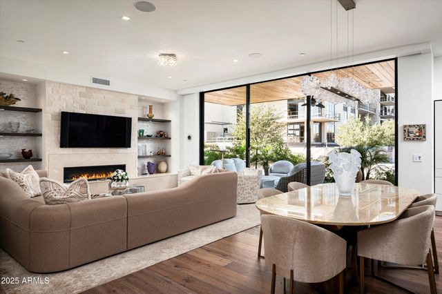a view of living room with patio furniture and potted plants