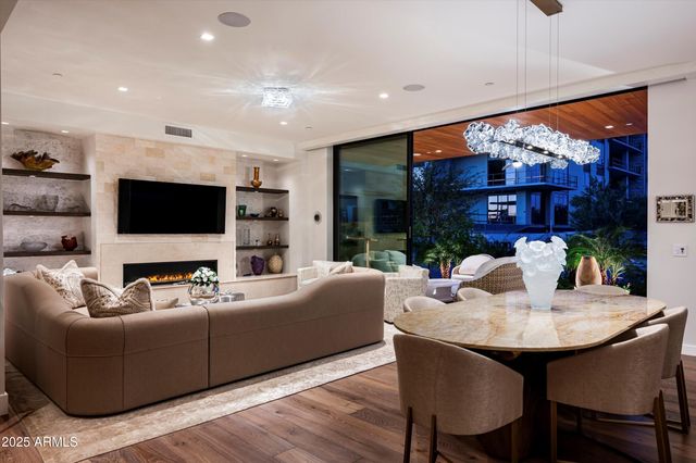 a living room with furniture fireplace and flat screen tv