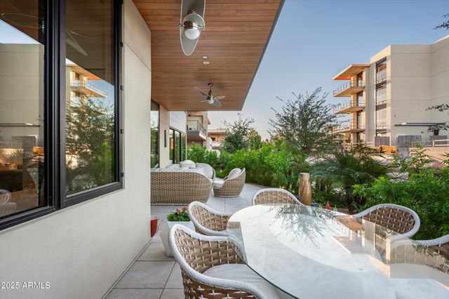a kitchen with stainless steel appliances granite countertop a sink dishwasher and white cabinets with wooden floor