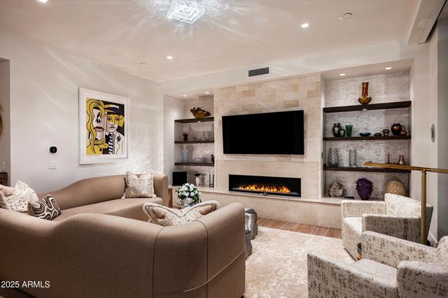 a bedroom with a bed and painting on the wall