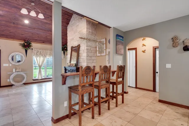 a view of a dining room with furniture and window