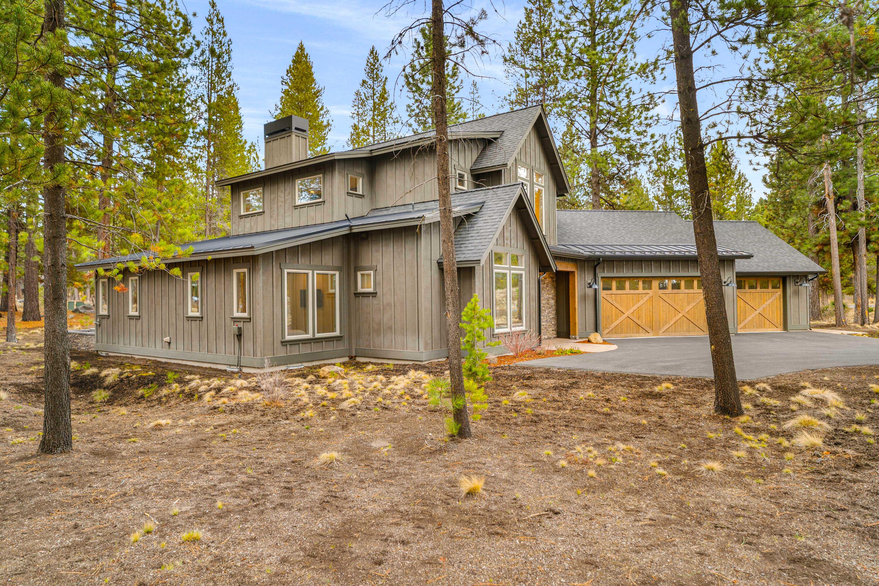 56302 Sable Rock Loop, Unit 255 Bend, OR 97707 - Photo 3 of 65 a front view of a house with a yard and garage