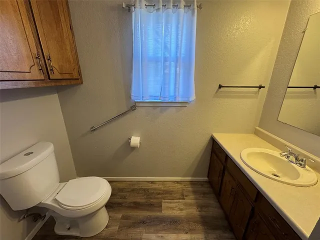 a bathroom with a sink a toilet and vanity