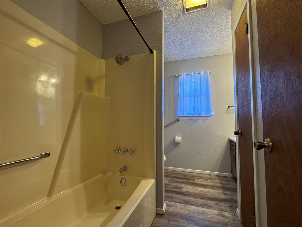 205 Wight Street Roxton, TX 75477 - Photo 12 of 22 a bathroom with a bathtub and a shower