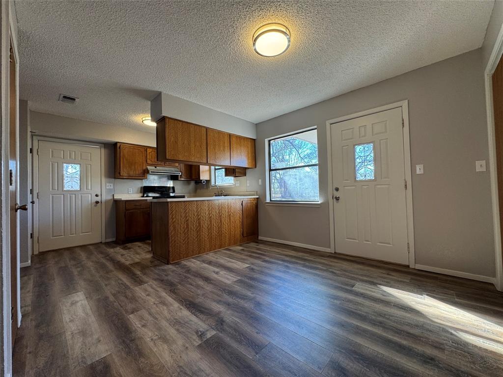 205 Wight Street Roxton, TX 75477 - Photo 14 of 22 a view of kitchen with wooden floor electronic appliances and window
