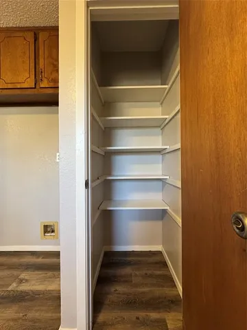 a view of walk in closet with empty racks