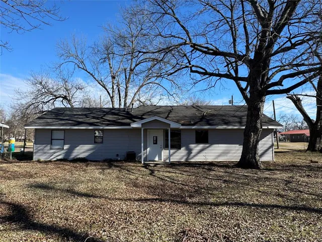 a house that has a tree in front of it