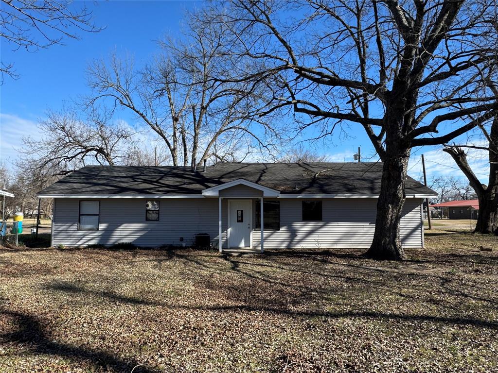 205 Wight Street Roxton, TX 75477 - Photo 19 of 22 a house that has a tree in front of it