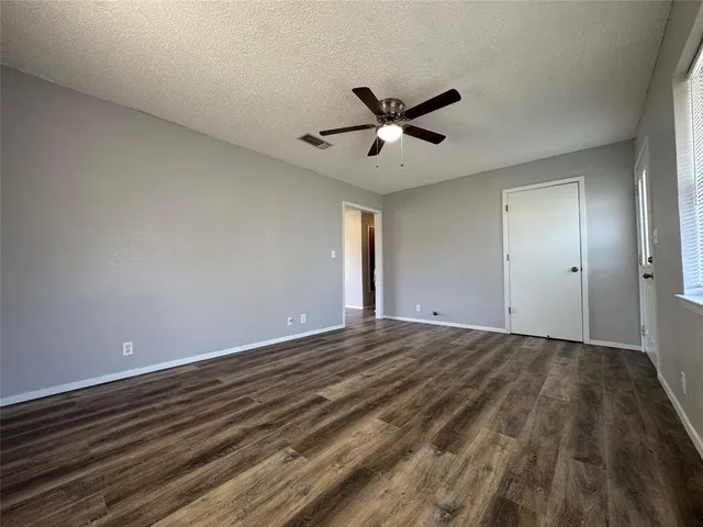 a view of an empty room and wooden floor