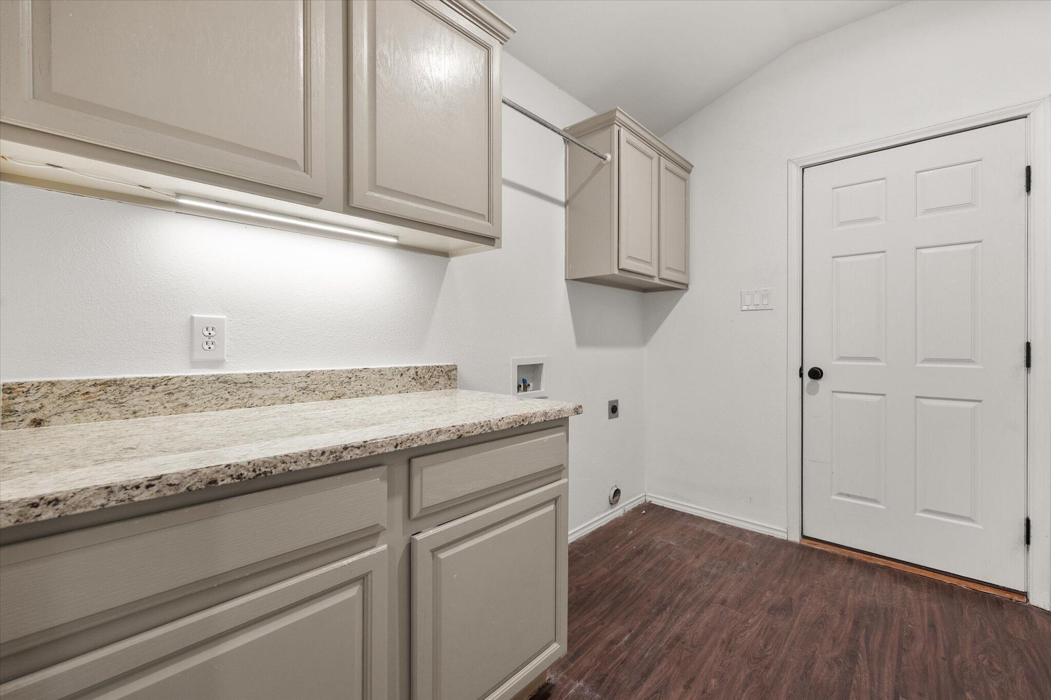 6104 Duke Street Lubbock, TX 79416 - Photo 17 of 28 a kitchen with granite countertop cabinets stainless steel appliances and a counter space