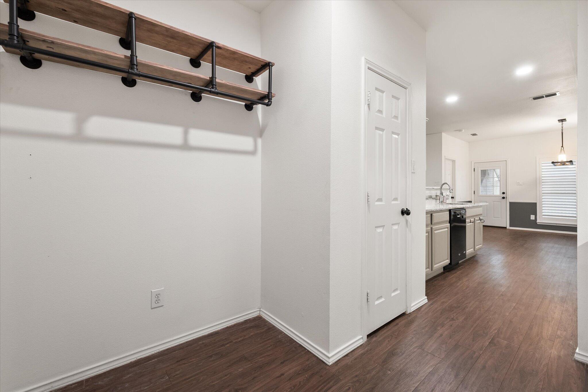 6104 Duke Street Lubbock, TX 79416 - Photo 18 of 28 a view of a kitchen with wooden floor