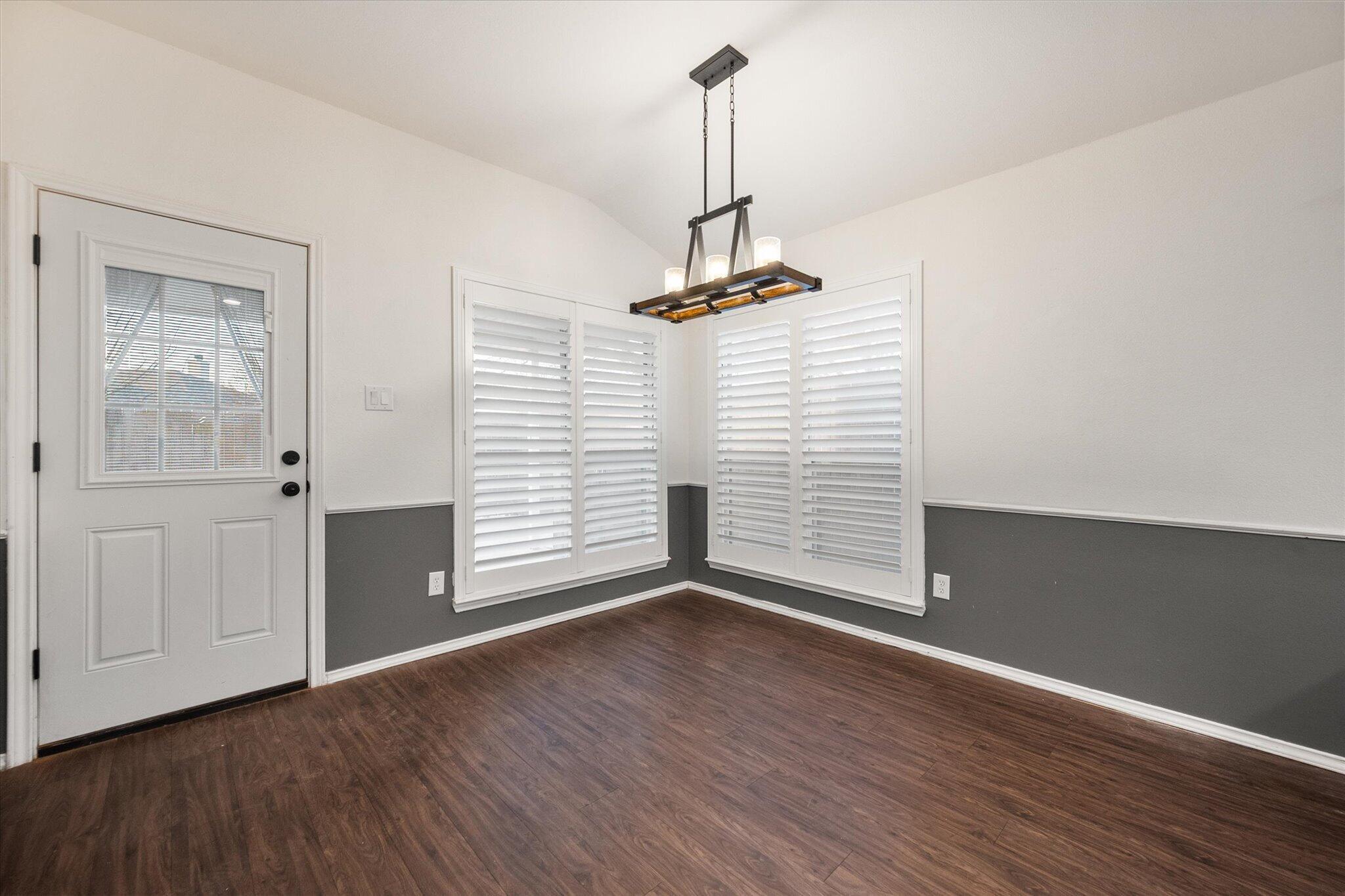 6104 Duke Street Lubbock, TX 79416 - Photo 19 of 28 a view of a room with wooden floor and white walls