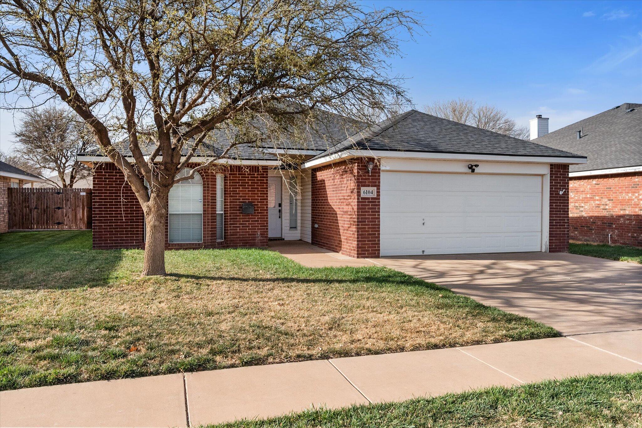6104 Duke Street Lubbock, TX 79416 - Photo 2 of 28 front view of a house with a yard