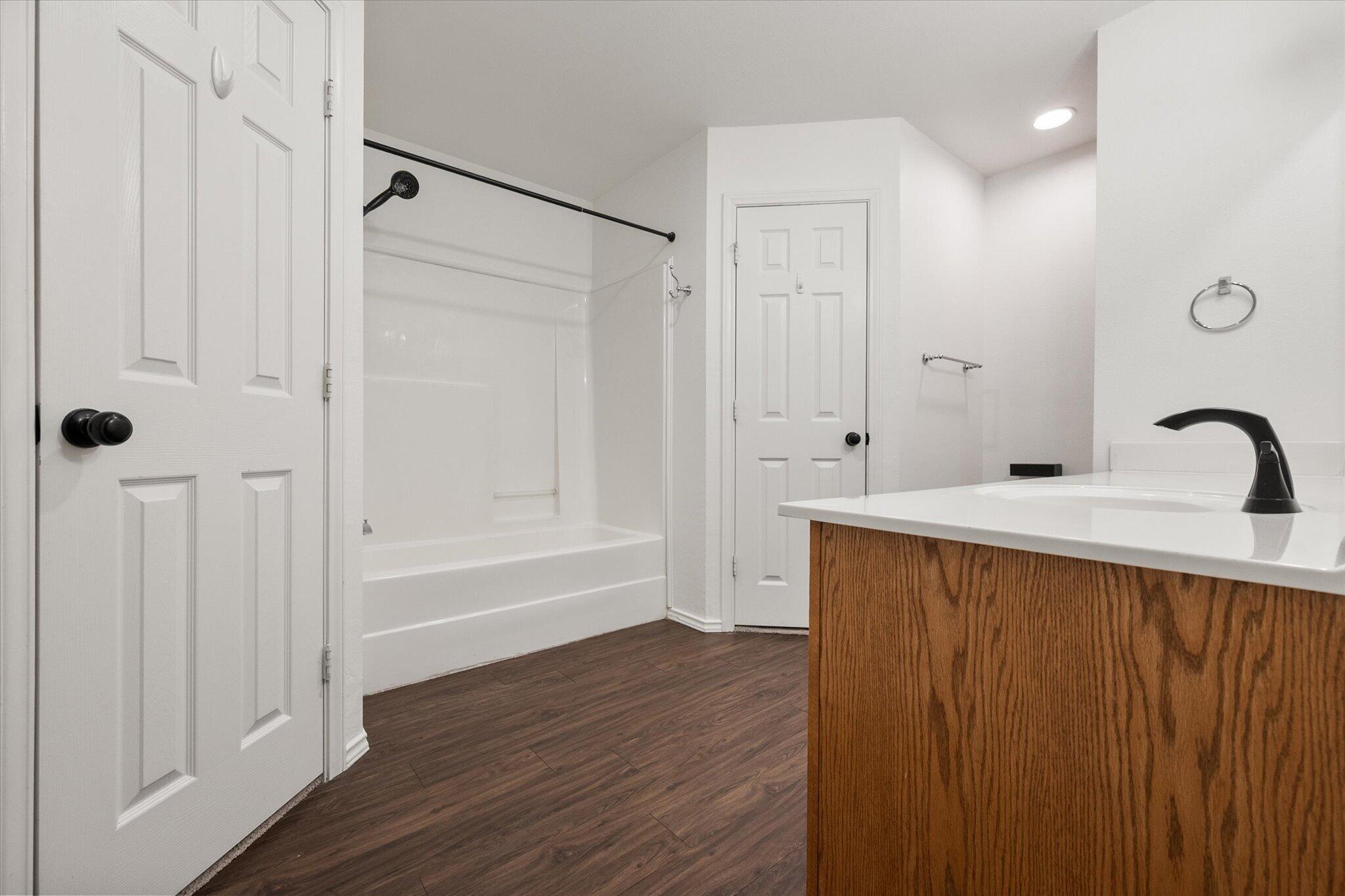 6104 Duke Street Lubbock, TX 79416 - Photo 23 of 28 a bathroom with a sink and a mirror