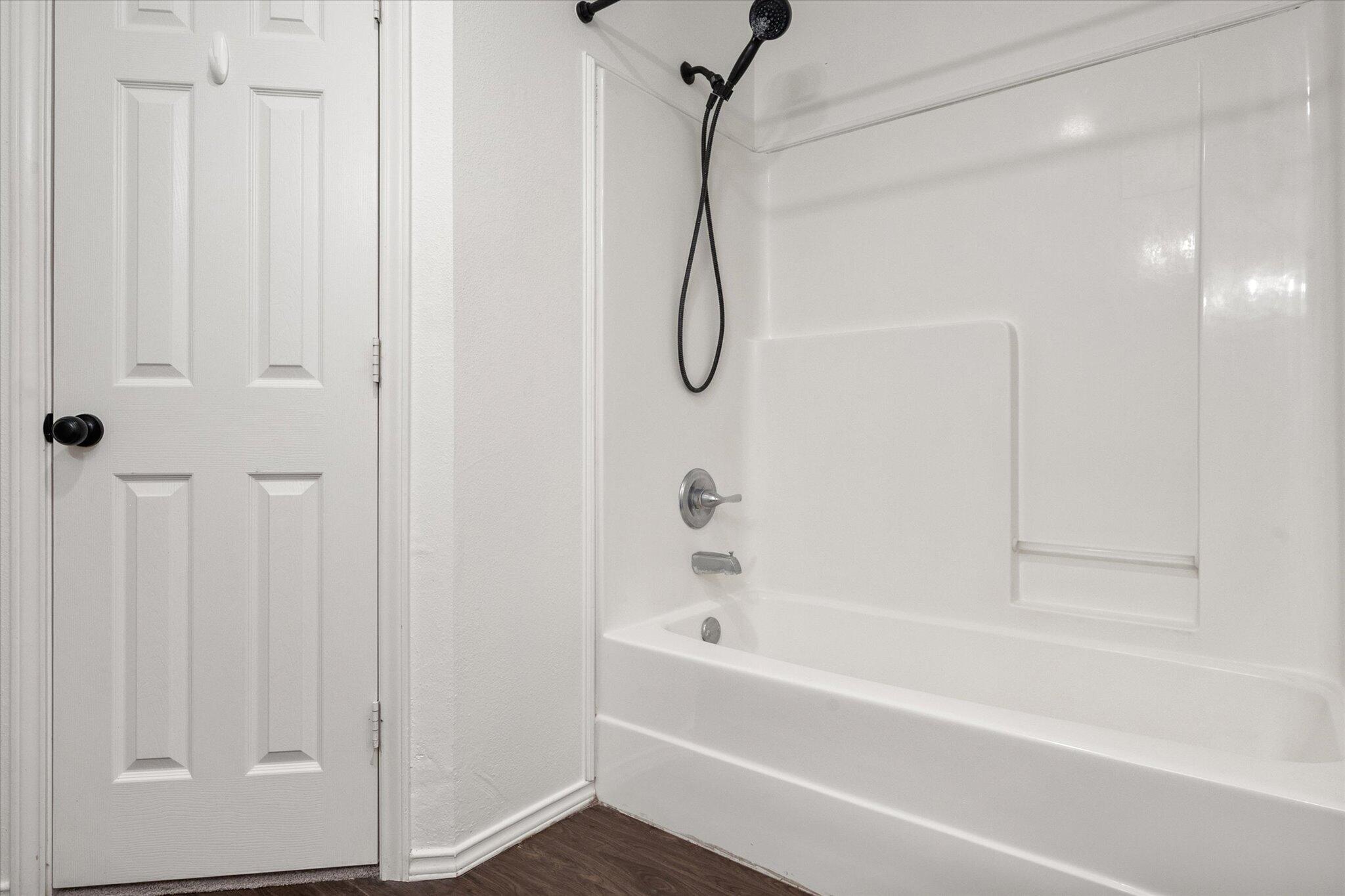 6104 Duke Street Lubbock, TX 79416 - Photo 25 of 28 a bathroom with a bath tub and shower