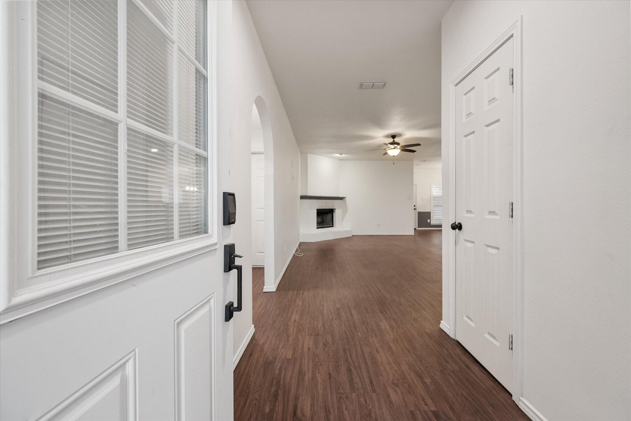 6104 Duke Street Lubbock, TX 79416 - Photo 3 of 28 a view of a hallway with wooden floor and staircase