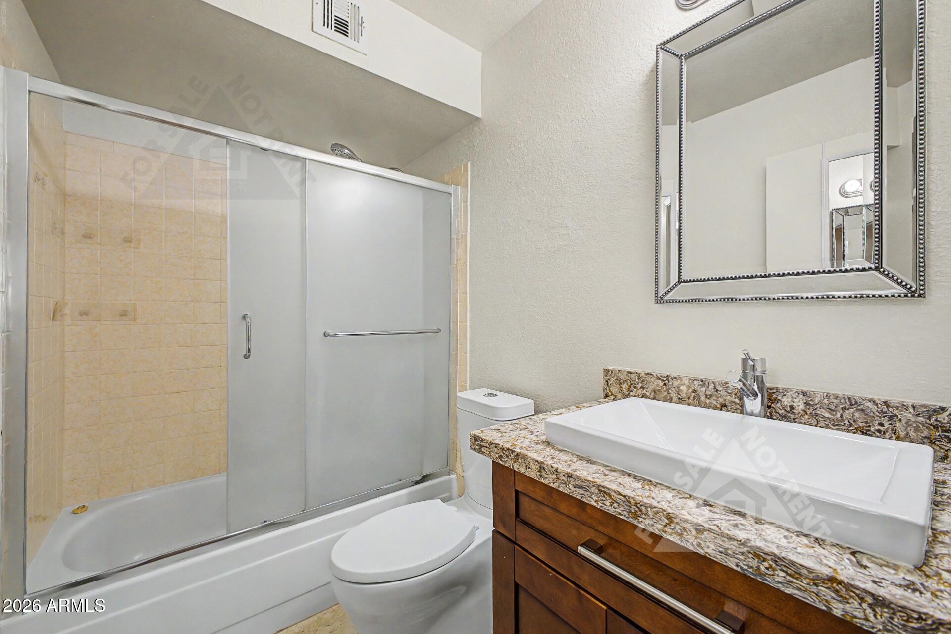 912 East Villa Rita Drive Phoenix, AZ 85022 - Photo 23 of 27 a bathroom with a granite countertop sink a toilet and shower