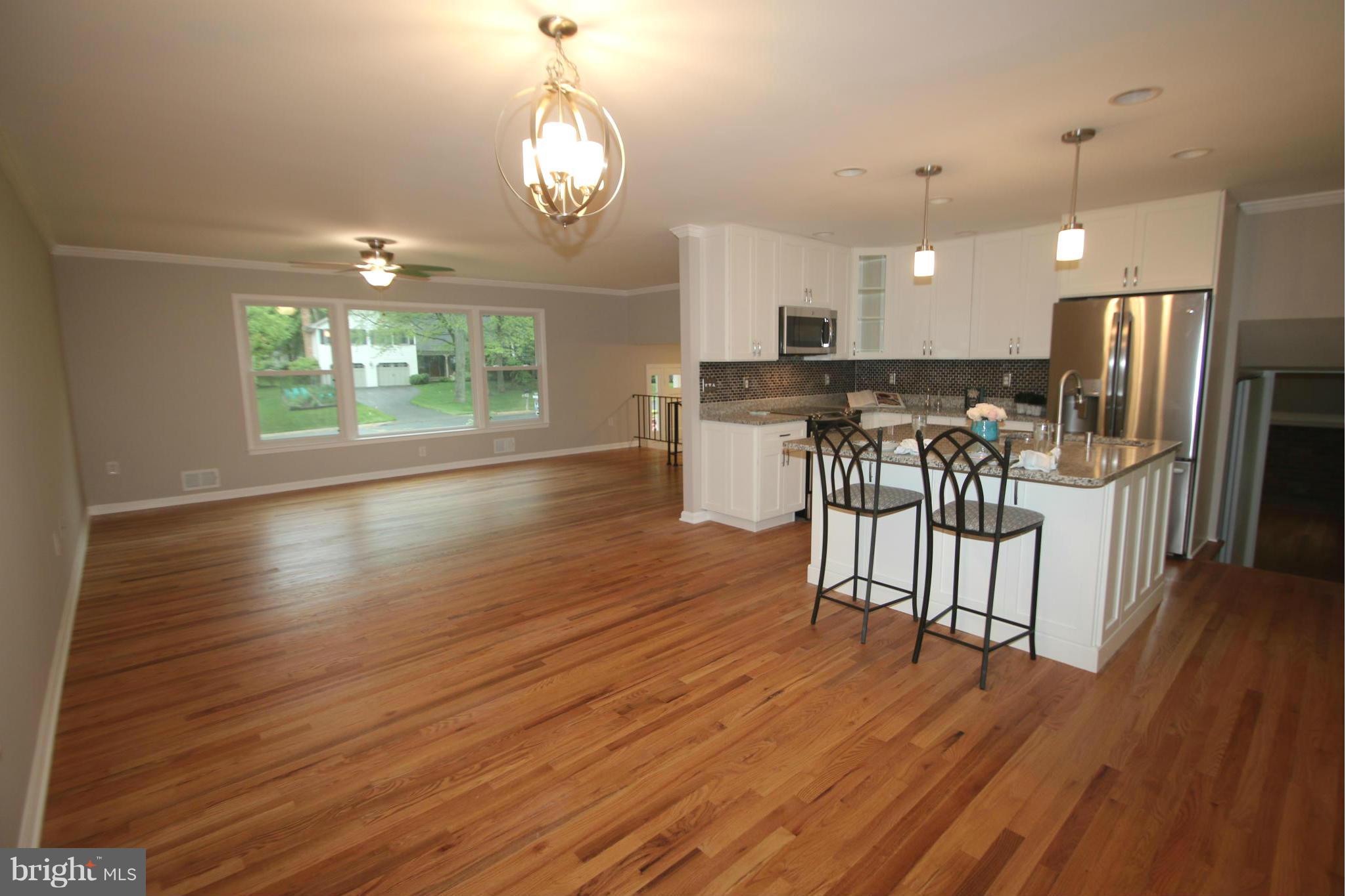 3405 Briars Road Brookeville, MD 20833 - Photo 2 of 21 an open kitchen with wooden floor and stainless steel appliances
