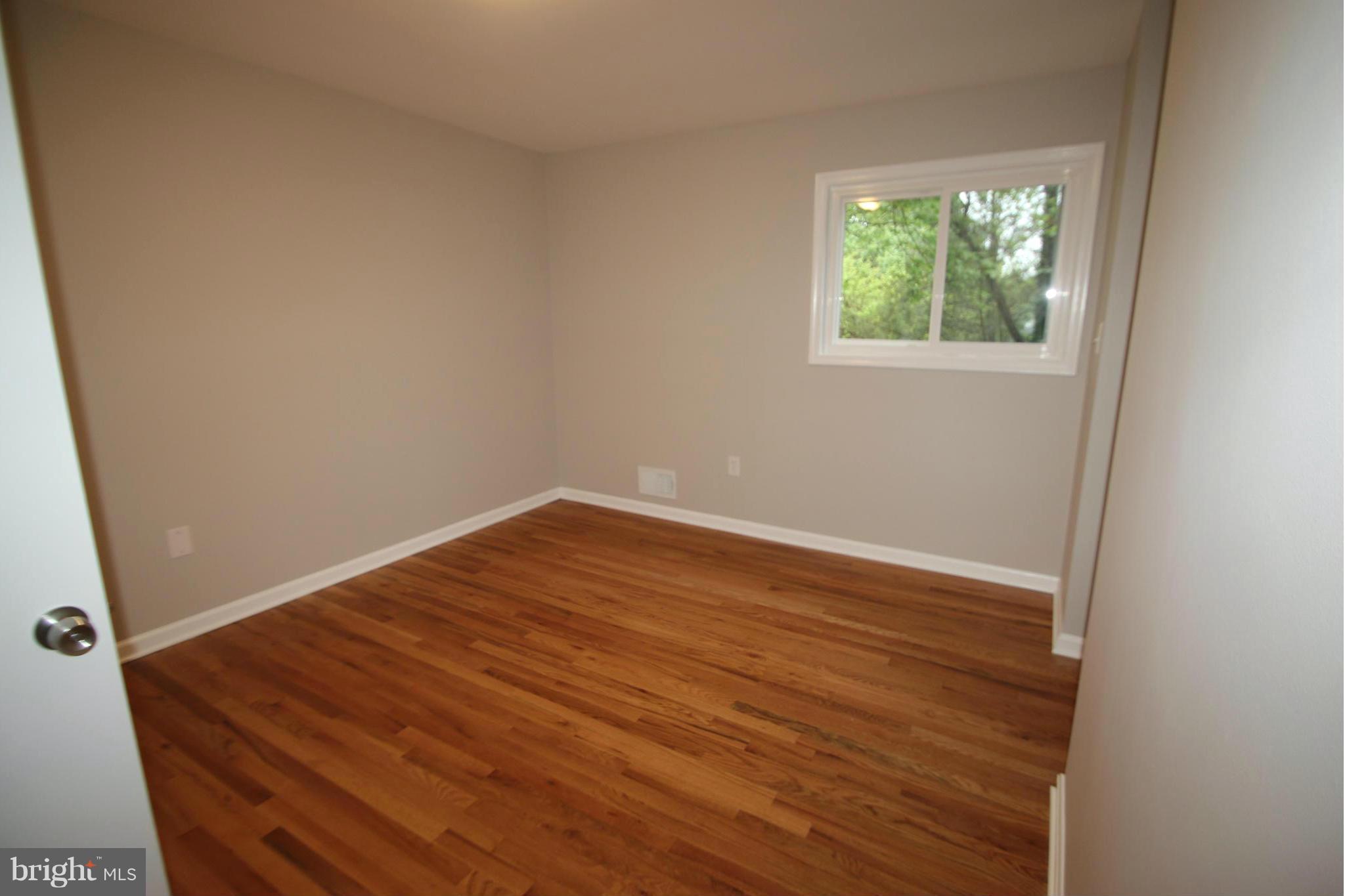 3405 Briars Road Brookeville, MD 20833 - Photo 11 of 21 an empty room with wooden floor and windows