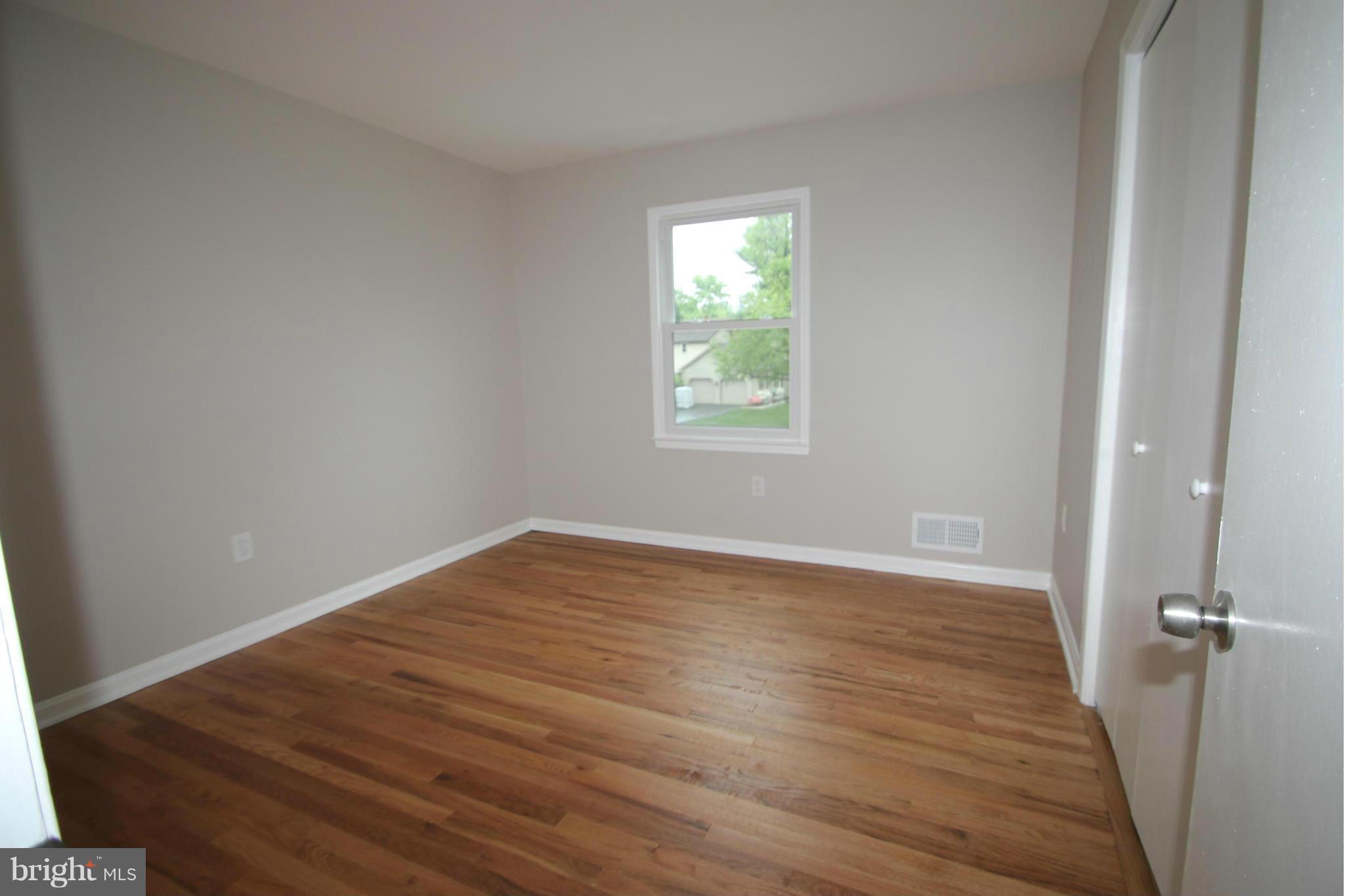 3405 Briars Road Brookeville, MD 20833 - Photo 13 of 21 wooden floor in an empty room with a window