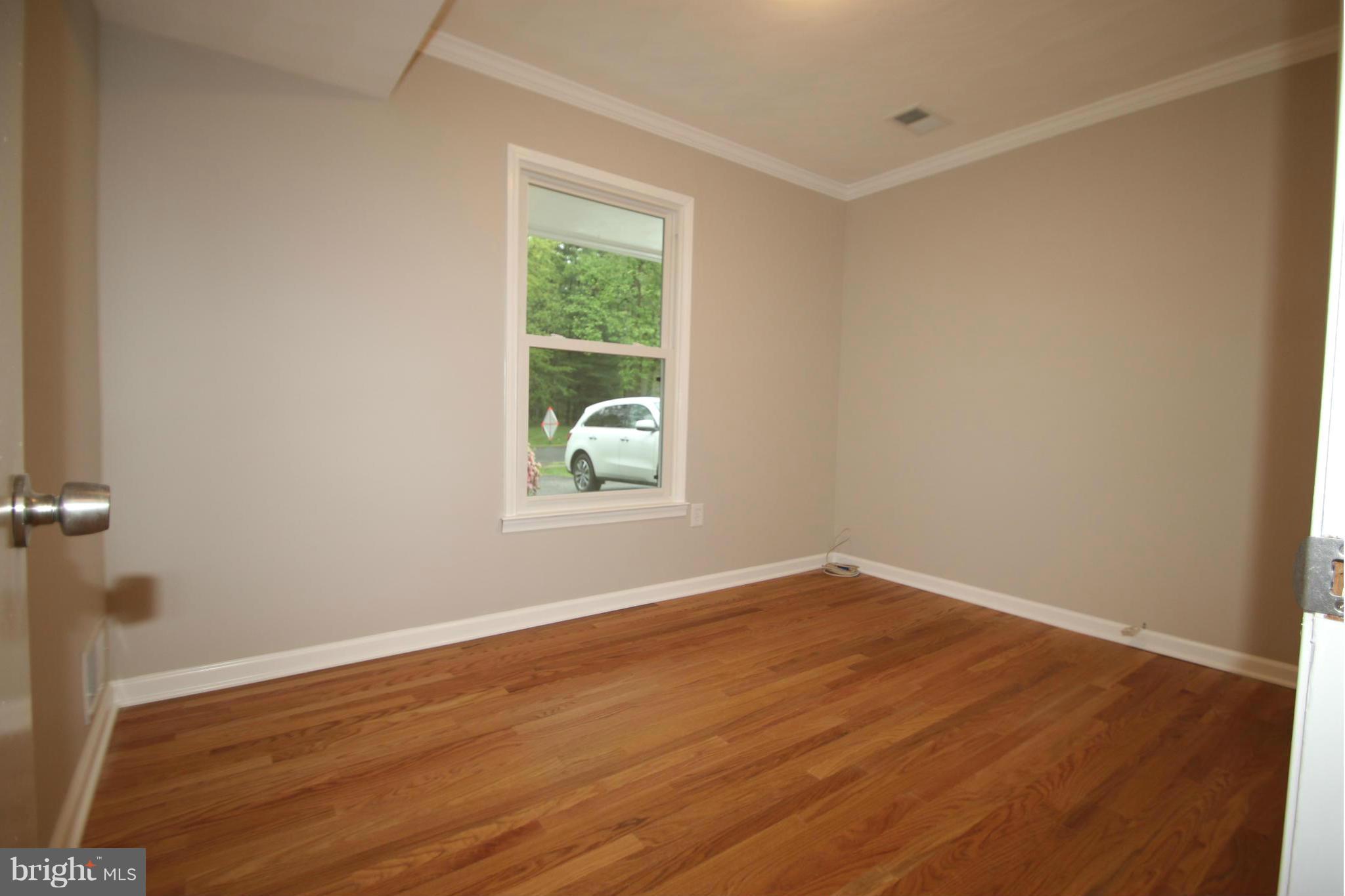 3405 Briars Road Brookeville, MD 20833 - Photo 15 of 21 an empty room with wooden floor and windows
