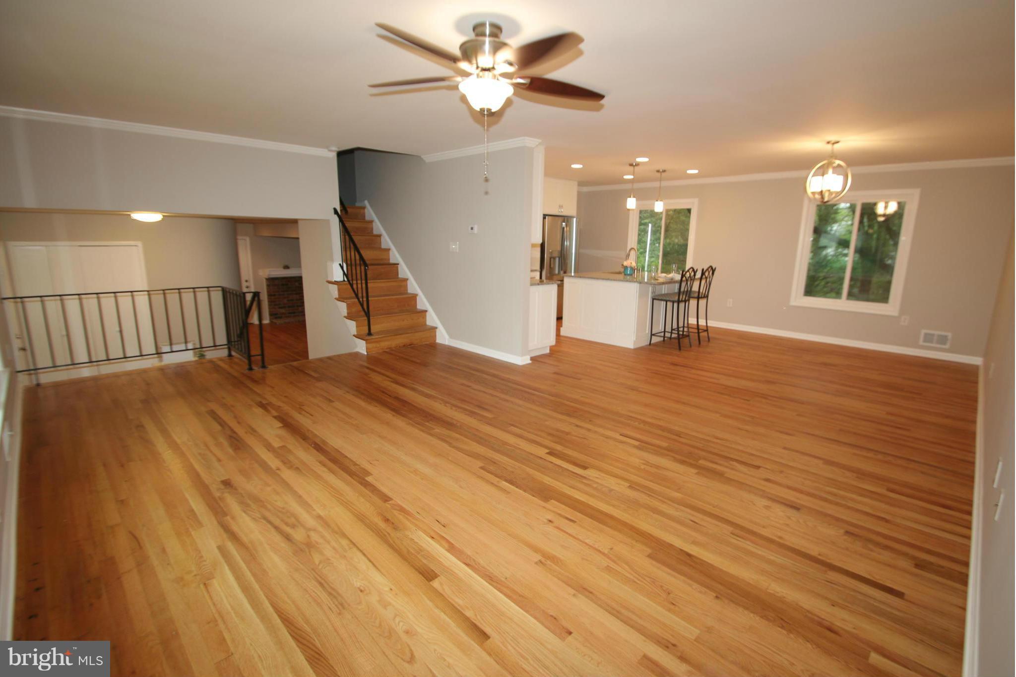 3405 Briars Road Brookeville, MD 20833 - Photo 5 of 21 a view of an empty room with wooden floor and a ceiling fan