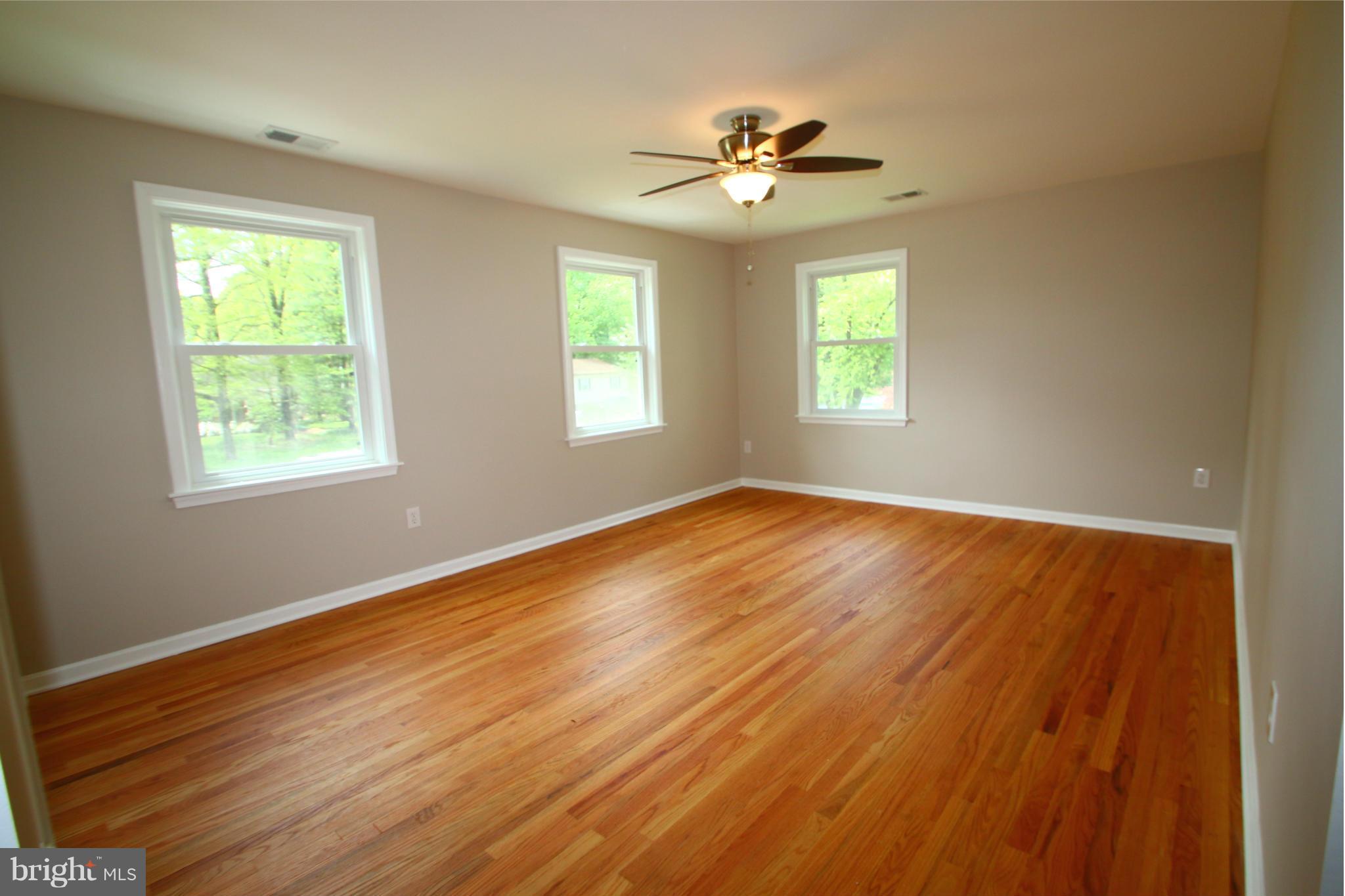 3405 Briars Road Brookeville, MD 20833 - Photo 7 of 21 a view of an empty room with wooden floor and a window