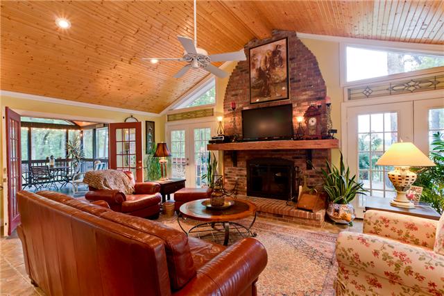 5247 Old Harding Road Fairview, TN 37062 - Photo 6 of 20 a living room with furniture a fireplace and a floor to ceiling window