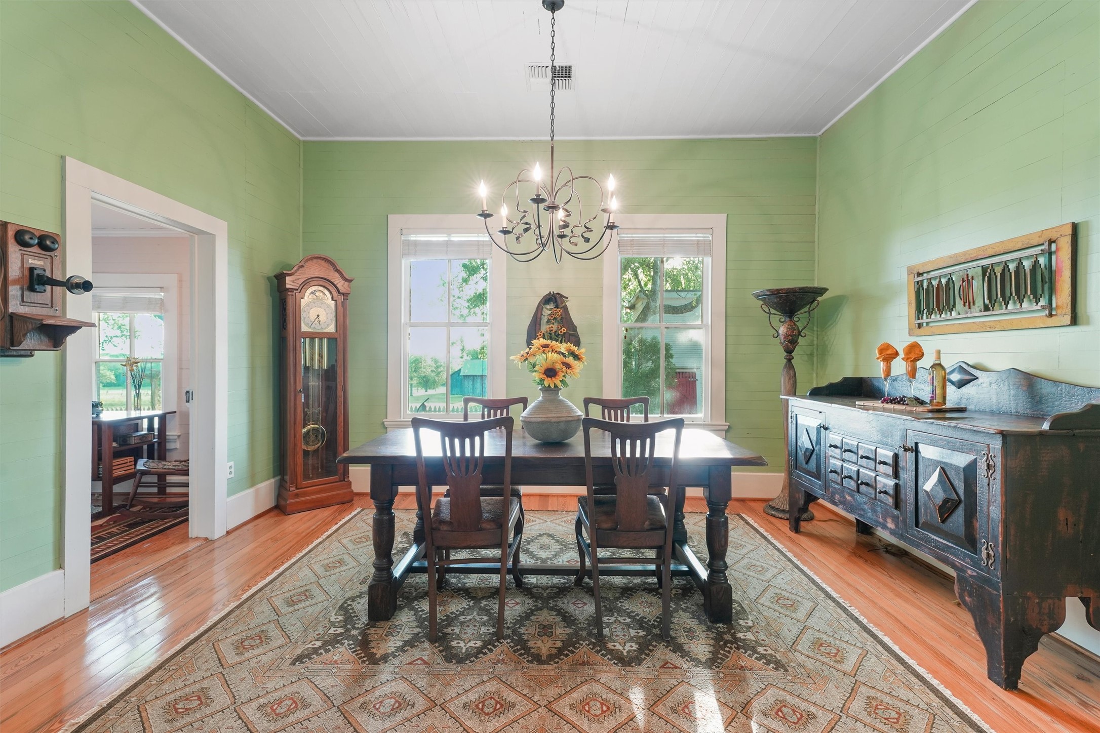 9058 Sam Houston Road Brenham, TX 77833 - Photo 12 of 50 a view of a dining room with furniture a chandelier and wooden floor