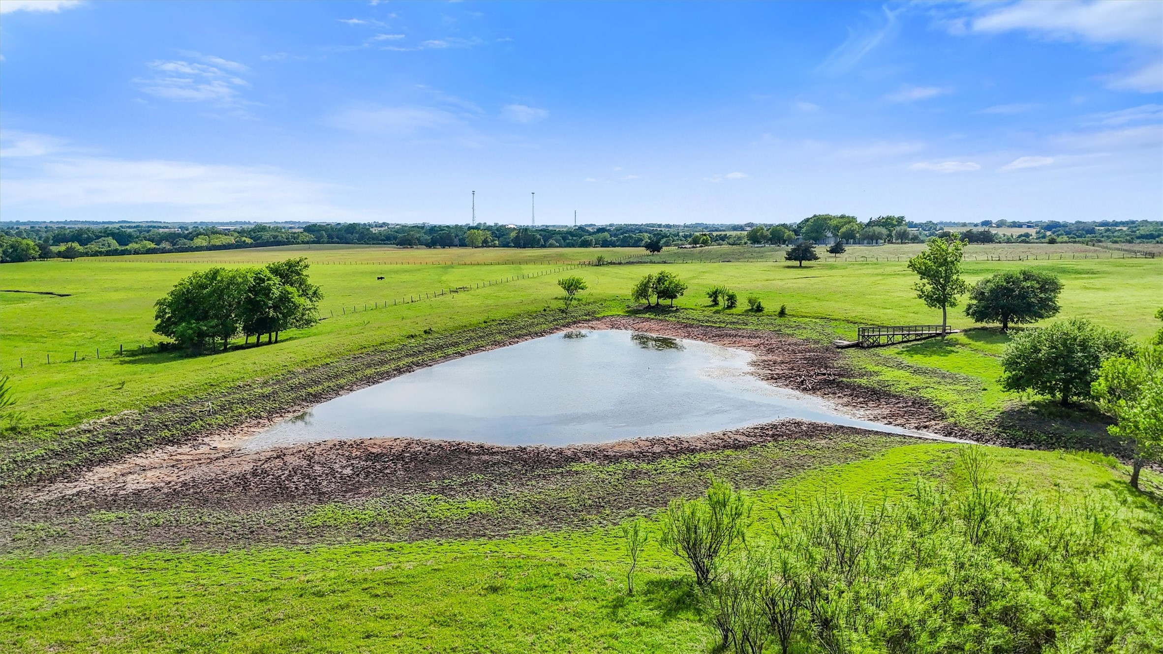 9058 Sam Houston Road Brenham, TX 77833 - Photo 39 of 50 a view of a lake with houses in the back