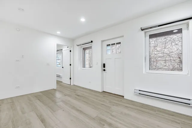 a bathroom with a sink a toilet a mirror and shower