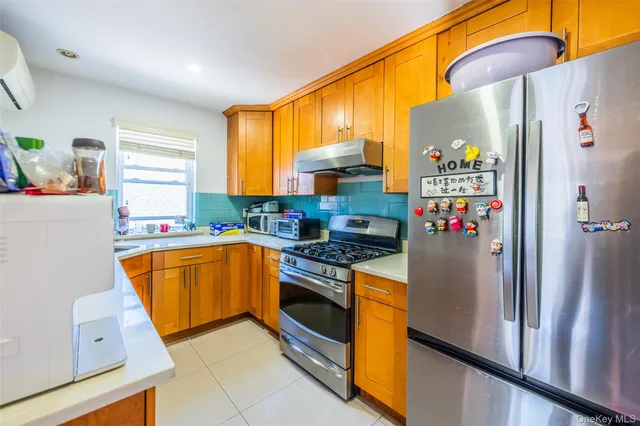 a kitchen with stainless steel appliances a stove a sink and a refrigerator