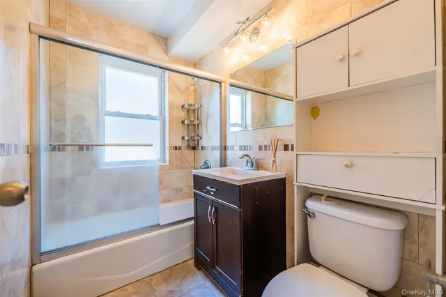 a bedroom with a bed a window and dresser